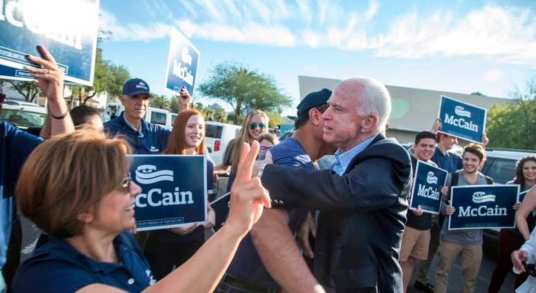 Nov 8, 2016; Phoenix, AZ, USA; Arizona senator John McCain and his wife Cindy McCain greet their supporters before he talks to the media after casting their ballots in the presidential election at Mountain View Christian Church.