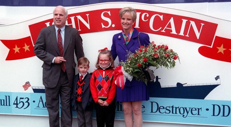 Sept. 26, 1996: Members of the christening for the guided missile destroyer JOHN S. MCCAIN (DDG-56) pose after the launching at the Bath Iron Works shipyard. From left to right: Sen. John McCain, his children, and spouse Cindy McCain.