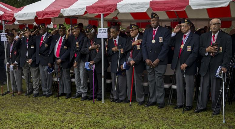 Montford Point Marines salute the colors during the Montford Point Marine Memorial gifting ceremony at the Montford Point Marine Memorial in Jacksonville, N.C., July 25, 2018.