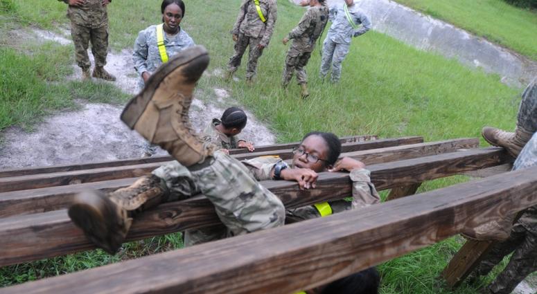 a medic with Special Troops Battalion, 3rd Infantry Division Sustainment Brigade, works her way through the “Weaver” obstacle on the Marne Mile Obstacle on Fort Stewart, Ga., June 2, 2017.
