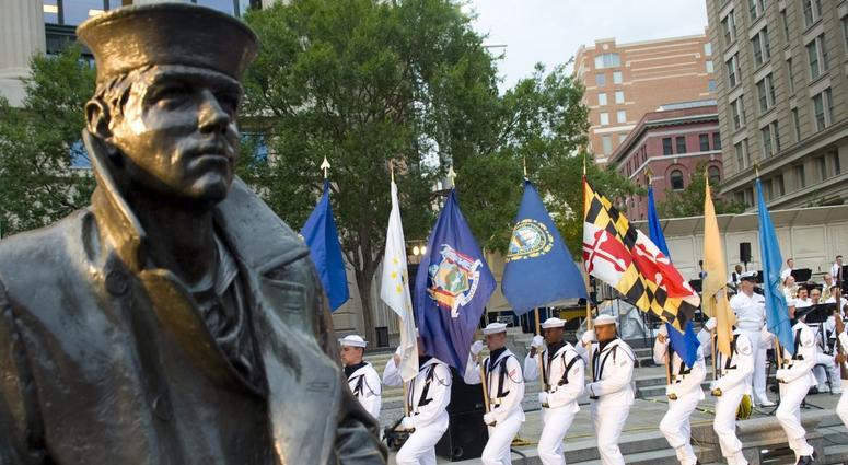 U.S. sailors parade the 50 state flags of America during the Concert on the Avenue series at the United States Navy Memorial in Washington, D.C., June 28, 2011.