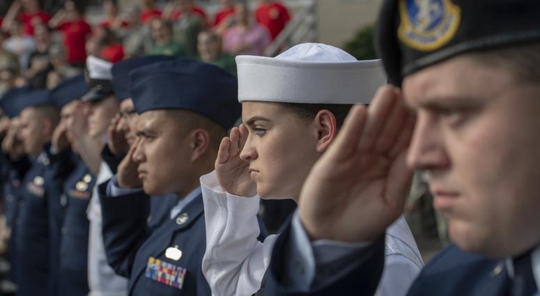 Service members salute during a ceremony for Memorial Day at Yokota Air Base, Japan, May 25, 2018. The 374th Airlift Wing hosted the ceremony in memory of those who made the ultimate sacrifice during military service.