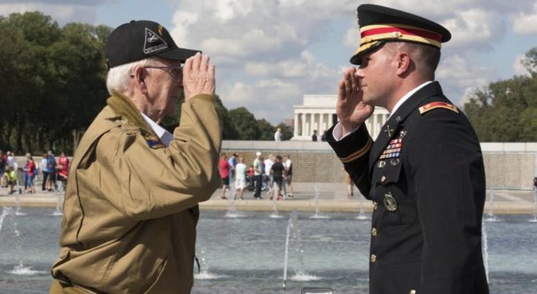Army Maj. Peter Semanoff salutes World War II veteran Clarence Smoyer