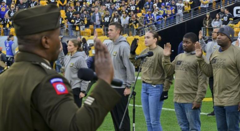Lt. Gen. Bruce Crawford, the Army's chief information officer, administers the oath of enlistment