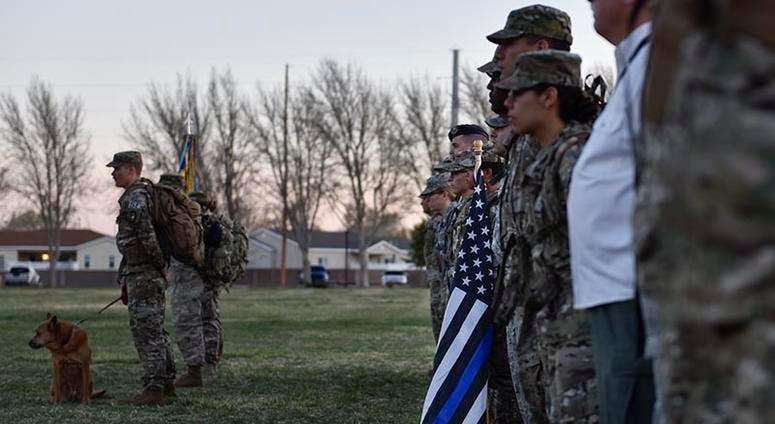 Participants of the 2019 377th Security Forces Squadron Suicide Awareness Ruck March stand in formation at Kirtland Air Force Base, N.M., March 29, 2019. The ruck march was created to support The Brave Badge Initiative Facebook page. 377thSecurityForcesSquadronSuicideAwarenessRuckMarch