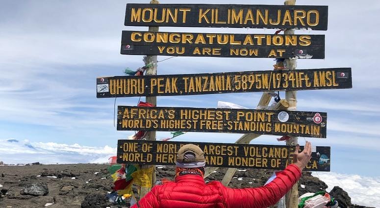 Adam Keys, a triple amputee, at the top of Mount Kilimanjaro--Africa's tallest peak.