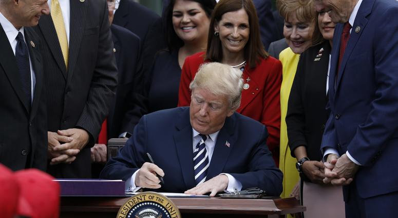 U.S. President Donald Trump signs the S. 2372-VA Mission Act of 2018 in the Rose Garden of the White House on June 6, 2018 in Washington, DC.