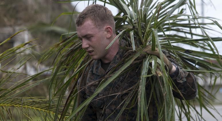 A Marine from the 31st Marine Expeditionary Unit cleans up debris after Typhoon Mangkhut