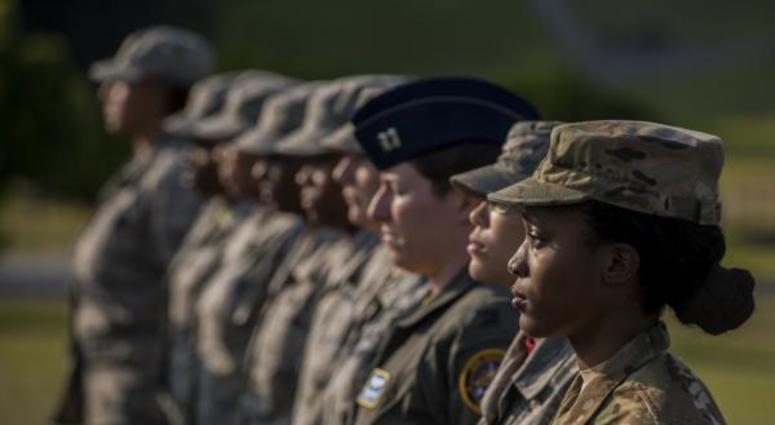 U.S. Air Force Airmen stand at attention during a retreat ceremony Mar. 30, 2018, on Kadena Air Base, Japan. An all-female formation was coordinated in honor of Women’s History Month, which brings attention to the accomplishments and achievements of women Air Force women at Kadena Air Base stand at attention during womens history month ceremony