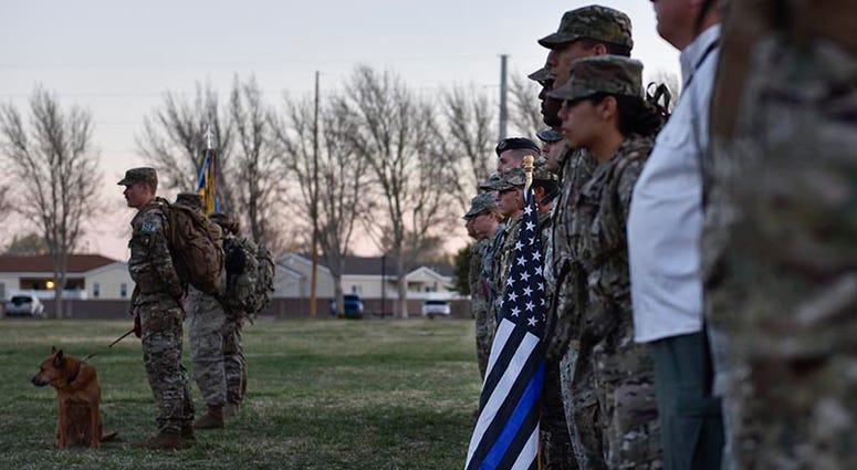 Participants of the 2019 377th Security Forces Squadron Suicide Awareness Ruck March stand in formation at Kirtland Air Force Base, N.M., March 29, 2019. The ruck march was created to support The Brave Badge Initiative Facebook page. 377thSecurityForcesSquadronSuicideAwarenessRuckMarch