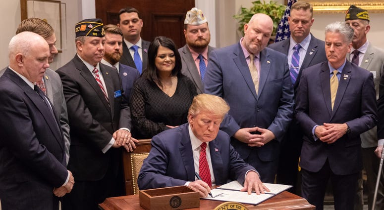 President Donald Trump signs an executive order for veteran suicide prevention at the White House on March 5, 2019. Veterans praise Trump's 2020 budget request