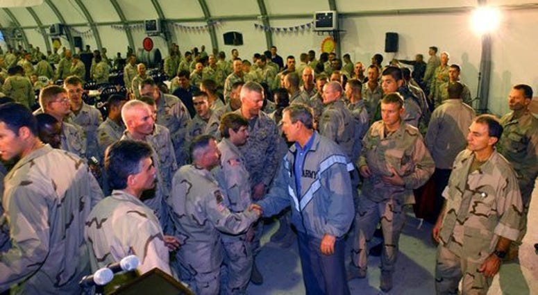 To show his support for America’s troops, President Bush makes a surprise visit to Iraq and shares Thanksgiving Dinner with U.S. troops at the Bob Hope Dining Facility, Baghdad, Iraq, Nov. 27, 2003.