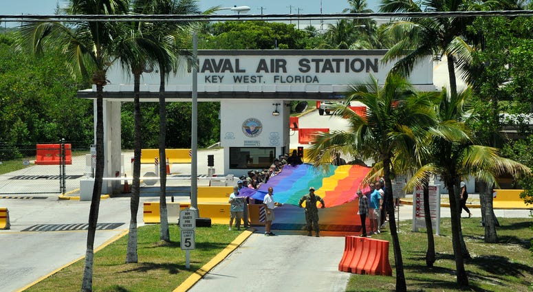 In honor of Lesbian, Gay, Bisexual and Transgender (LGBT) Pride Month, Naval Air Station Key West’s Sailors and civilians display a 100-foot section of the original Key West sea-to-sea Pride Flag in front of the main gate Wednesday.