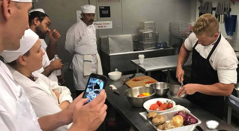 Vets2success founder Bryan Jacobs demonstrates a cooking technique