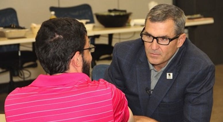 WWP CEO Mike Linnington, a retired Army General, speaks to a veteran at an event. Wounded Warrior Project CEO Mike Linnington (r) served in the Army for over 30 years