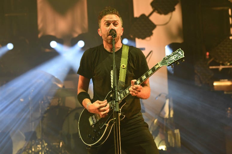 Tim McIlrath of Rise Against performs at the Bayfront Park Amphitheatre. Tim McIlrath of Rise Against performs at the Bayfront Park Amphitheatre.