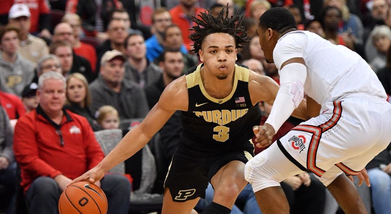 Photo of a Ohio State player guarding a Purdue player.