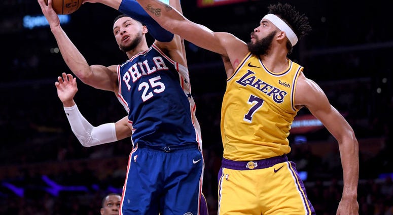 Photo of Javale McGee trying to block Ben Simmons' shot.