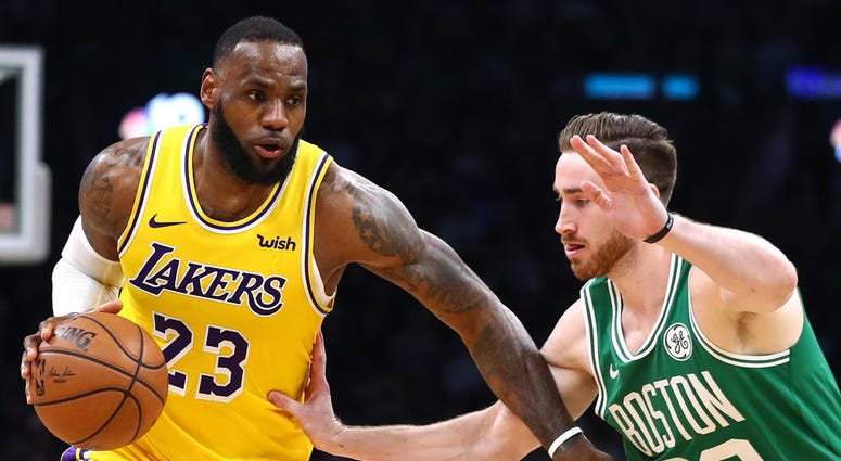 Photo of a Boston player guarding a Los Angeles player.
