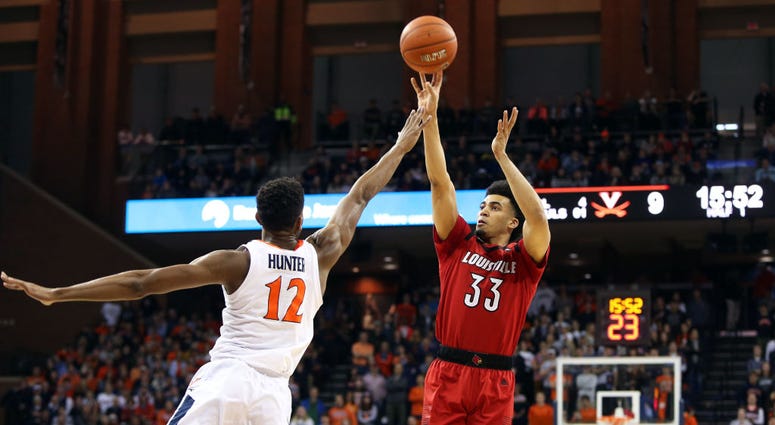 Photo of a Virginia player contesting a Louisville player's shot.