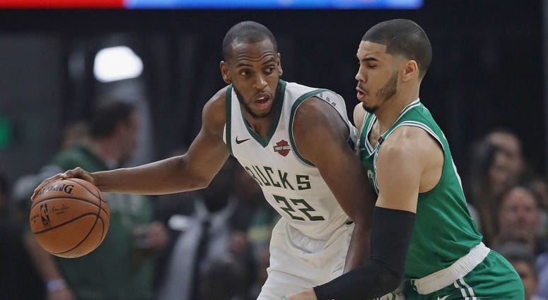 Photo of a Celtics player defending the Bucks player.