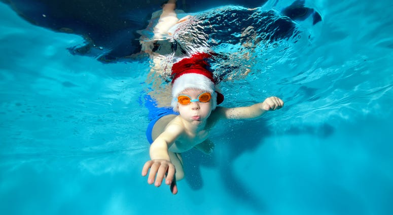Kid Swimming in Santa Hat