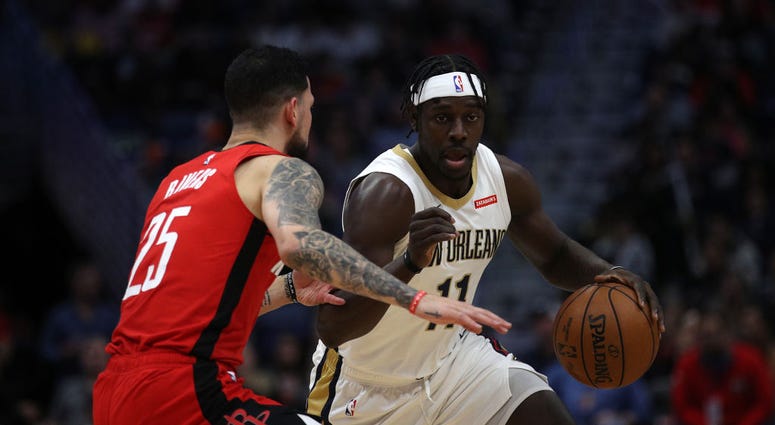 Photo of Austin Rivers guarding Jrue Holiday.