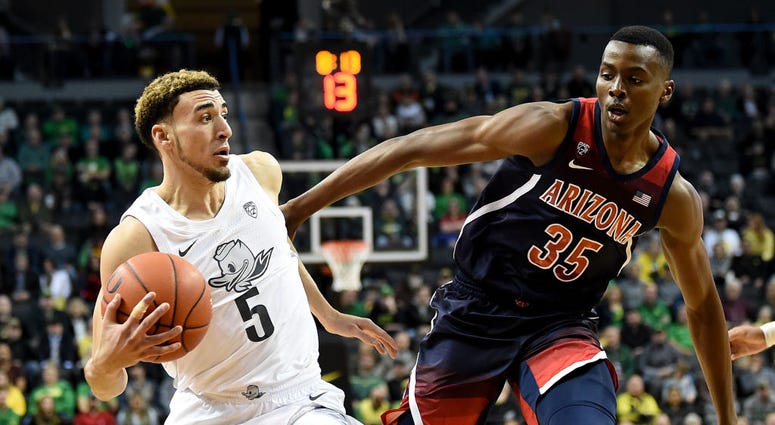 Photo of an Arizona player guarding an Oregon player.