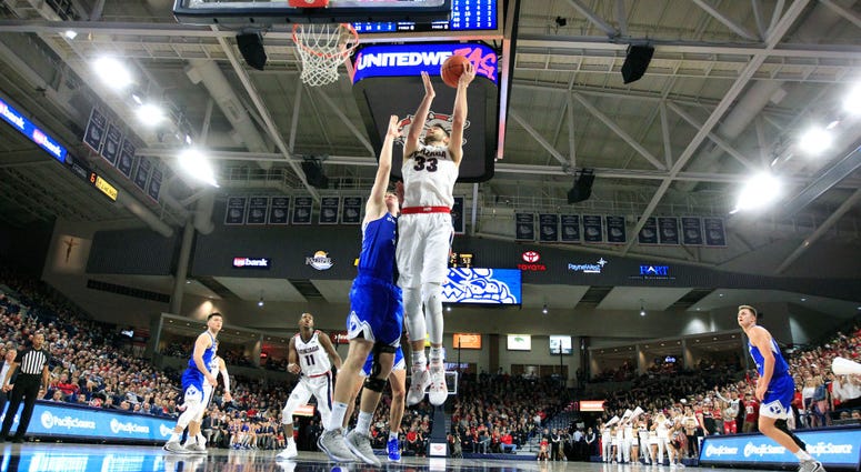 Photo of a BYU player contesting a Gonzaga player's layup.