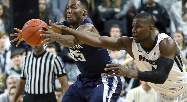 photo of a Providence and Villanova players fighting for the ball.