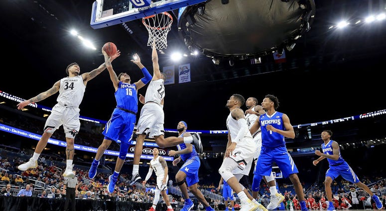 Photo of a Memphis and Cincinnati players going up for a rebound.