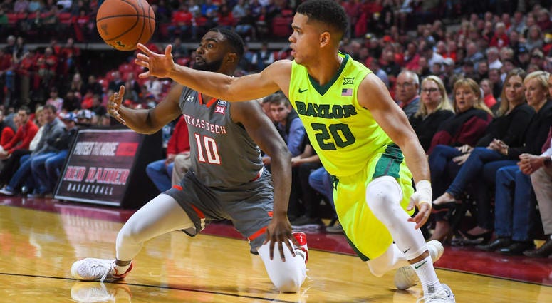 Photo of a Baylor and Texas Tech player fighting for the ball.