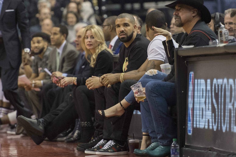 Canadian recording artist Drake watches the action during the first quarter in a game between the Golden State Warriors and the Toronto Raptors at Air Canada Centre. Canadian recording artist Drake watches the action during the first quarter in a game between the Golden State Warriors and the Toronto Raptors at Air Canada Centre.