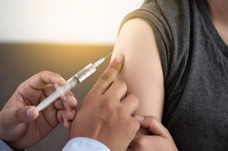 Medicine and health care concept Doctor giving patient vaccine