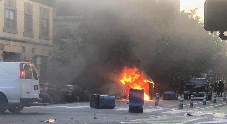 A dumpster burns at a George Floyd protest in San Jose.