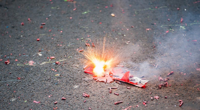 Firecracker exploding in the street Firecracker exploding in the street