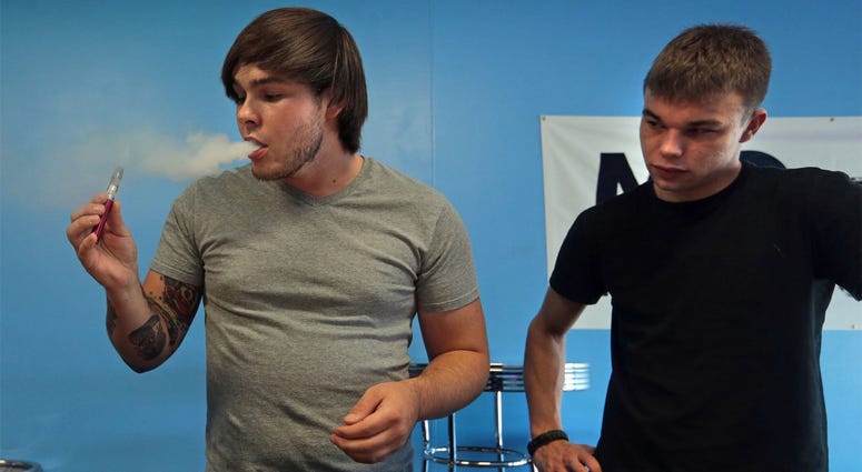 E-Cigarettes "I come in here all the time and sample the juice flavors," said Mike Reynolds, left, who vapes a watermelon juice e-cigarette on Sunday, Sept. 28, 2014, at MOvape Electronic Cigarette Store in St. Louis. His friend Taylor Kreter is on the right. (Photo b