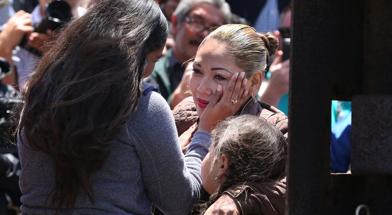 Borderfield State Park in San Diego Isela Michel Zavala wipes a tear from her mother Yudridia Guadalupe Zavala, whose arm is draped over Isela's daughter Briana Montes, as they meet in the Door of Hope at Borderfield State Park in San Diego on April 30, 2016. The Door of Hope was opened for