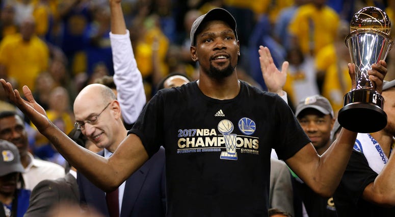 Kevin Durant The Golden State Warriors' Kevin Durant holds the Finals MVP trophy after defeating the Cleveland Cavaliers, 129-120, in Game 5 of the NBA Finals at Oracle Arena in Oakland, Calif., on Monday, June 12, 2017. (Photo by Nhat V. Meyer/Bay Area News Group/TNS