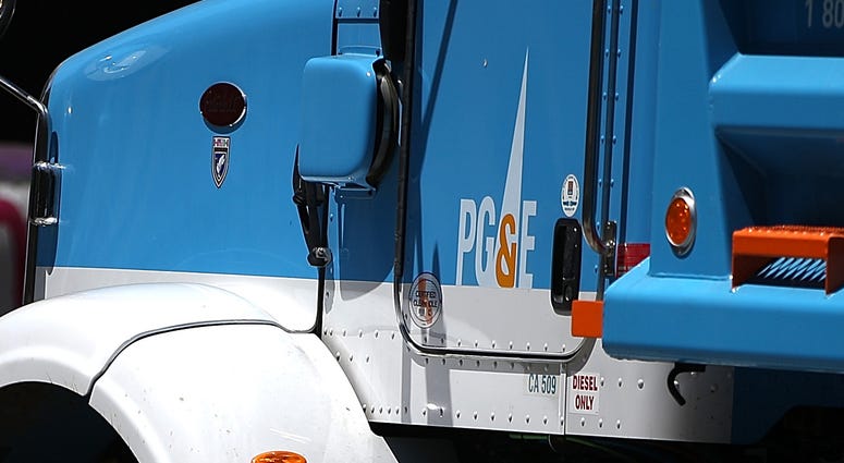 PG&E Truck SAN FRANCISCO, CA - JULY 30: Pedestrians walk by a Pacific Gas and Electric (PG&E) truck at a job site on July 30, 2014 in San Francisco, California. A federal grand jury has added 27 new charges, including obstruction of justice, the criminal case agains