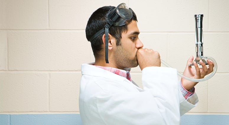 Male student performing an experiment Male student performing an experiment (Photo credit: Shannon Fagan)