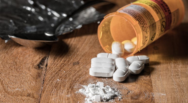 Oxycodone Opioid Tablets Oxycodone is the generic name for a range of opoid pain killing tablets. Prescription bottle for Oxycodone tablets and pills on wooden table for opioid epidemic illustration