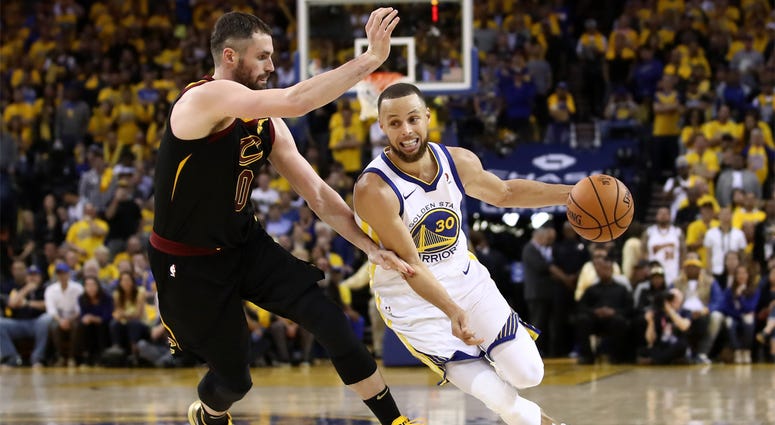 2018 NBA Finals - Game 1 OAKLAND, CA - MAY 31: Stephen Curry #30 of the Golden State Warriors drives to the basket defended by Kevin Love #0 of the Cleveland Cavaliers in Game 1 of the 2018 NBA Finals at ORACLE Arena on May 31, 2018 in Oakland, California.