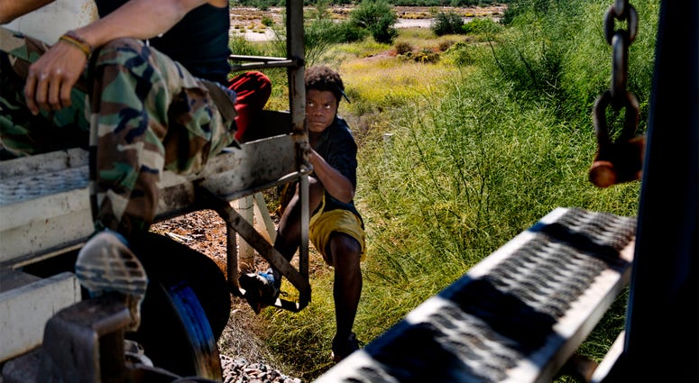 La Bestia aka "The Beast" Oct 25, 2016; Sonora, Mexcio; A Honduran migrant jumps aboard a moving freight train in Mexico headed toward the U.S. border south of Caborca, Sonora. There are many cases of migrants who have lost legs after falling off the freight trains, known as La Be