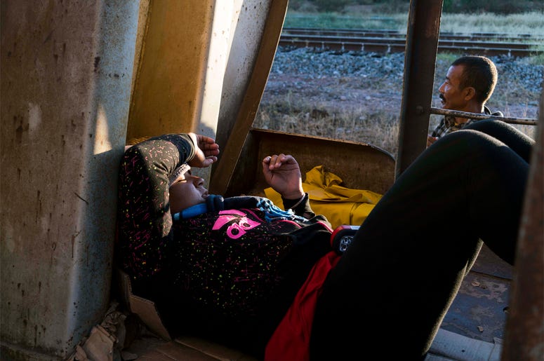 Migrants on La Bestia, or "The Beast" Oct 25, 2016; Sonora, Mexcio; A Honduran women traveling on a freight train, known by migrants as La Bestia, the beast, rests inside a train car south of Caborca, Sonora, about four hours from the border with Arizona. There has been a sharp rise in the nu
