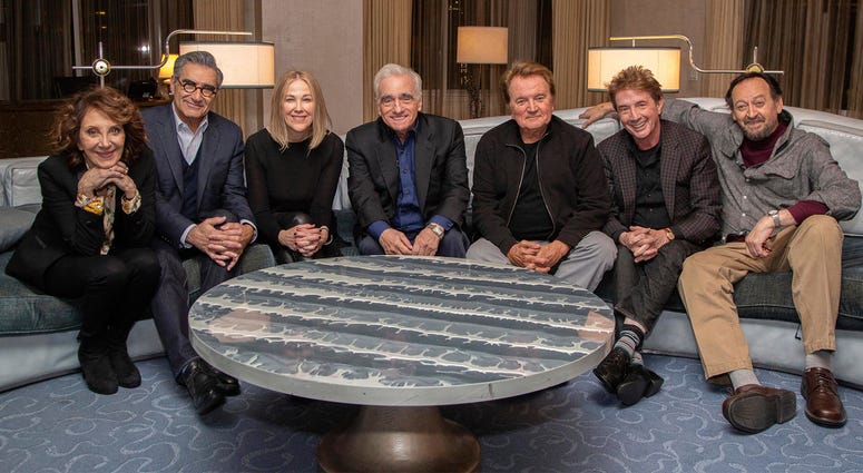 AP18102642419477 This undated image released by Netflix shows director Martin Scorsese, center, with the cast of the Canadian sketch comedy show “SCTV,” from left, Andrea Martin, Eugene Levy, Catherine O'Hara, Dave Thomas, Martin Short and Joe Flaherty. Netflix announced