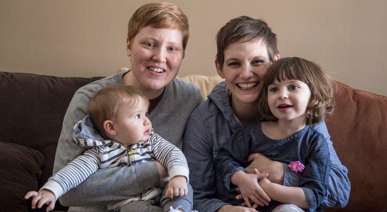 AP18102771415711 In this March 3, 2018 photo provided by the Ad Council, Jami Contreras, left, and her wife, Krista Contreras, pose for a photo with their children, Sylas and Bay, in Oak Park, Mich. Krista and Jamie took Bay to the doctor at six days old for her first doc