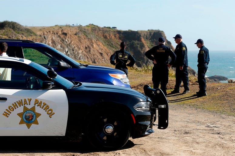 AP18103739505475 FILE - In this March 28, 2018, file photo, California Highway Patrol officers and deputy sheriffs from Mendocino and Alameda counties gather after a search for three missing children at the site where the bodies of Jennifer and Sarah Hart and three of the