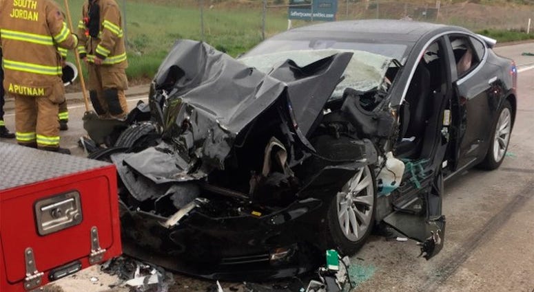 AP18132748380899 In this Friday, May 11, 2018, photo released by the South Jordan Police Department shows a traffic collision involving a Tesla Model S sedan with a Fire Department mechanic truck stopped at a red light in South Jordan, Utah. Witnesses indicated the Tesla