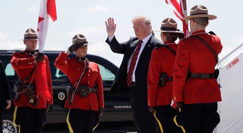 AP18159540009839 President Donald Trump arrives for the G7 Summit, Friday, June 8, 2018, in Canadian Forces Base Bagotville, Canada. (AP Photo/Evan Vucci)